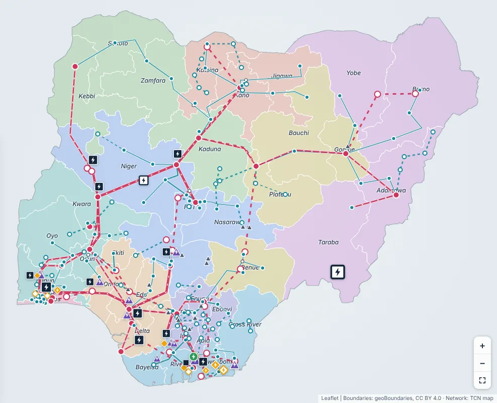 Map of Nigeria showing 330 kV and 132 kV transmission lines, substations and power plants over coloured DisCo areas